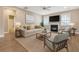 Cozy living room with a fireplace, neutral furniture, large windows and a ceiling fan at 602 Yellow Leaf Ln, Summerville, SC 29486