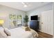 Cozy bedroom with a window, ceiling fan, and dresser with a TV at 700 Daniel Ellis Dr # 5103, James Island, SC 29412