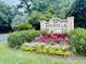 A Peninsula community welcome sign surrounded by colorful landscaping at 700 Daniel Ellis Dr # 5103, James Island, SC 29412