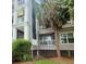 View of a multi-story residential building with balconies, landscaping, and an adjacent palm tree at 700 Daniel Ellis Dr # 5103, James Island, SC 29412