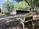Park bench near a beautiful tennis court surrounded by nature at 700 Daniel Ellis Dr # 5103, James Island, SC 29412