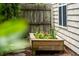 Backyard with a wooden planter box with herbs and flowers, surrounded by stepping stones and a privacy fence at 708 Lawton Harbor Dr, Charleston, SC 29412