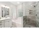 Bright bathroom featuring a separate tub and walk-in shower with stylish gray and white tiling at 708 Lawton Harbor Dr, Charleston, SC 29412