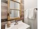 Charming bathroom with decorative wood wall, framed mirror, and white vanity at 708 Lawton Harbor Dr, Charleston, SC 29412