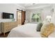 Stylish bedroom with a sliding barn door to the bathroom, modern decor, and a comfortable seating area at 708 Lawton Harbor Dr, Charleston, SC 29412