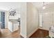 Bright entryway and kitchen area featuring hardwood floors, white cabinetry, and granite counters at 708 Lawton Harbor Dr, Charleston, SC 29412