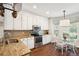 Bright, eat-in kitchen featuring white cabinets, granite countertops, and stainless steel appliances at 708 Lawton Harbor Dr, Charleston, SC 29412
