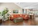 Spacious living room featuring a large sectional sofa, hardwood floors, and an open layout leading to the dining area at 708 Lawton Harbor Dr, Charleston, SC 29412