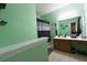 Well-lit bathroom featuring a vanity with wood cabinets and a framed mirror at 714 Alwyn Blvd, Summerville, SC 29485