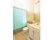 Bright bathroom with white tile floor, a light blue shower curtain, and white vanity at 714 Alwyn Blvd, Summerville, SC 29485