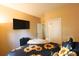Bright bedroom showcases a mounted television and closet doors near a comfortable bed at 714 Alwyn Blvd, Summerville, SC 29485