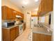Kitchen with wood cabinetry, white appliances, and tile floors, offering a clean and functional space at 714 Alwyn Blvd, Summerville, SC 29485