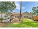 Spacious backyard with patio, screened porch, and lush lawn, perfect for outdoor entertaining and relaxation at 801 Long Drive Rd, Summerville, SC 29485