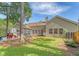 Back exterior view with large screened porch, patio, and fenced backyard for outdoor enjoyment at 801 Long Drive Rd, Summerville, SC 29485