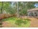 Spacious backyard with lush green lawn, patio, and screened porch, offering a serene outdoor retreat at 801 Long Drive Rd, Summerville, SC 29485