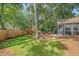 Backyard featuring a spacious lawn, patio, screened porch, and privacy fence, ideal for outdoor activities at 801 Long Drive Rd, Summerville, SC 29485