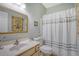 Well-maintained bathroom with traditional vanity and a shower-tub combo with decorative curtain at 801 Long Drive Rd, Summerville, SC 29485