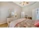 Bright bedroom featuring hardwood floors, a ceiling fan, a queen bed and dresser at 801 Long Drive Rd, Summerville, SC 29485