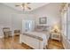 Serene bedroom featuring hardwood floors, a ceiling fan, a queen bed and a bathroom entry at 801 Long Drive Rd, Summerville, SC 29485