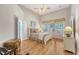 Comfortable bedroom with hardwood floors, a ceiling fan, and a large window providing natural light at 801 Long Drive Rd, Summerville, SC 29485