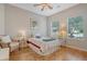 Cozy bedroom with a ceiling fan, two windows, hardwood floors, and a comfortable single bed at 801 Long Drive Rd, Summerville, SC 29485