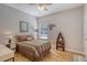 Inviting bedroom featuring wood floors, nautical accents, and a comfortable bed with a decorative headboard at 801 Long Drive Rd, Summerville, SC 29485