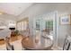 Cozy dining area with outdoor access and views into the living room featuring tile floors and a round table with four chairs at 801 Long Drive Rd, Summerville, SC 29485
