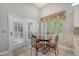 Bright dining area with a round table, four chairs, a large window with decorative valance, and access to outdoor patio at 801 Long Drive Rd, Summerville, SC 29485