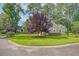 Beautifully landscaped property featuring lush green lawn, mature trees and attractive curb appeal at 801 Long Drive Rd, Summerville, SC 29485
