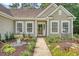 Inviting home entrance with manicured garden, water feature and cozy bench seating at 801 Long Drive Rd, Summerville, SC 29485