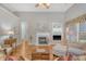 Open living space with a fireplace, hardwood floors, and abundant natural light at 801 Long Drive Rd, Summerville, SC 29485