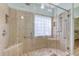 Tiled shower with dual showerheads, built-in benches, and clear glass enclosure in modern bath at 801 Long Drive Rd, Summerville, SC 29485