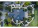 Aerial view of a building with a dark roof, surrounded by parking, sidewalks, trees, and a golf course at 8725 Herons Walk, North Charleston, SC 29420