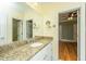 Bathroom featuring a granite countertop vanity, mirror, and neutral color scheme at 8725 Herons Walk, North Charleston, SC 29420
