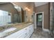 Spacious bathroom featuring double sinks, granite countertop, and a glass-enclosed shower at 8725 Herons Walk, North Charleston, SC 29420