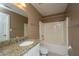 Bathroom with granite countertop vanity, white cabinets, and tub with shower at 8725 Herons Walk, North Charleston, SC 29420