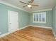Bedroom featuring hardwood floors, a ceiling fan, and natural light from window with shutters at 8725 Herons Walk, North Charleston, SC 29420