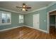Bedroom with hardwood floors, ceiling fan, and natural light from two windows at 8725 Herons Walk, North Charleston, SC 29420