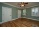 Bedroom with hardwood floors, ceiling fan, and natural light from the windows at 8725 Herons Walk, North Charleston, SC 29420
