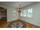 Cozy dining room with hardwood floors, plantation shutters, and a classic chandelier at 8725 Herons Walk, North Charleston, SC 29420