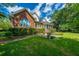 Well-maintained two-story brick home with manicured lawn, landscaped yard, and mature trees at 8725 Herons Walk, North Charleston, SC 29420