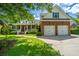 Charming brick home with a manicured lawn and a two-car garage on a sunny day at 8725 Herons Walk, North Charleston, SC 29420