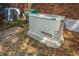 Generac generator installed on gravel bed behind brick home with A/C units at 8725 Herons Walk, North Charleston, SC 29420