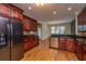 Well-appointed kitchen with rich wood cabinetry, stainless steel appliances, and granite countertops at 8725 Herons Walk, North Charleston, SC 29420
