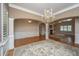 Spacious living room featuring hardwood floors, decorative columns and a stylish chandelier at 8725 Herons Walk, North Charleston, SC 29420