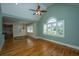 Bright, open living area featuring hardwood floors, shuttered windows and connected to another room at 8725 Herons Walk, North Charleston, SC 29420