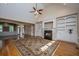 Open-concept living space with hardwood floors, built-in shelving and fireplace at 8725 Herons Walk, North Charleston, SC 29420