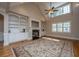 Bright living room featuring a fireplace with built-in shelves and large windows at 8725 Herons Walk, North Charleston, SC 29420