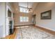 Bright living room with a fireplace, hardwood floors, and tall windows at 8725 Herons Walk, North Charleston, SC 29420