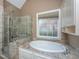 Elegant bathroom with a soaking tub and a glass-enclosed shower at 8725 Herons Walk, North Charleston, SC 29420